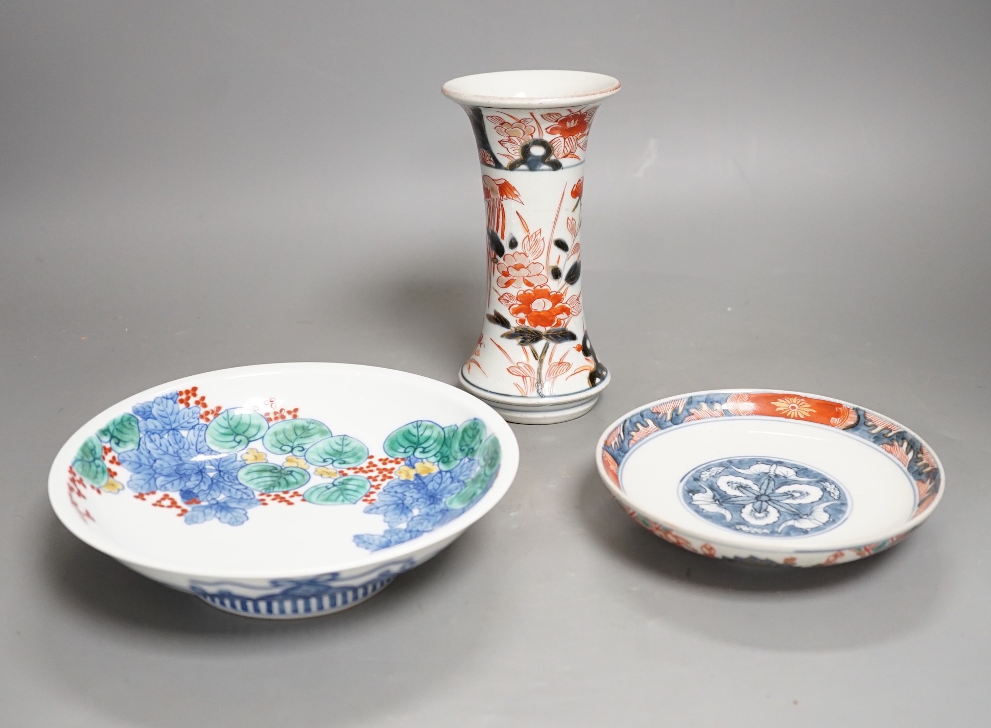 An 18th century Japanese Arita porcelain vase, a Nabeshima style dish and an Arita dish, height of vase 17cm